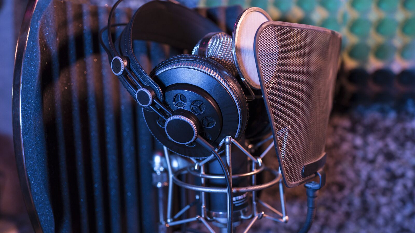 Headphones resting on a studio microphone in a shock mount
